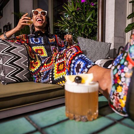 Qt Melbourne Hotel Exterior photo A woman drinking a beer